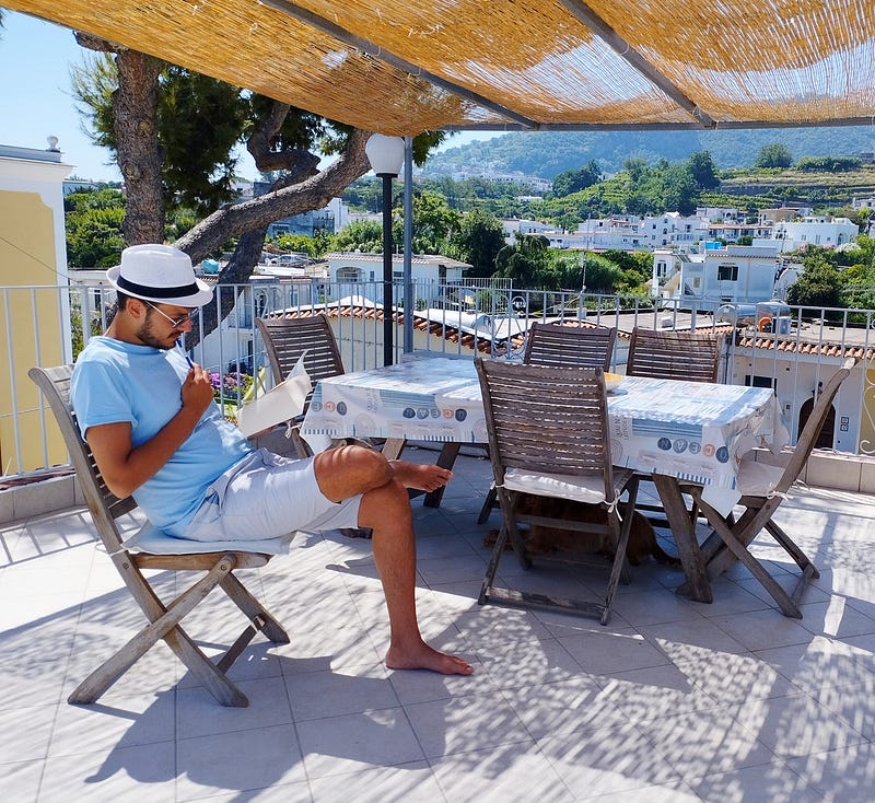 Antonello Mirone (Art Historian). Reading Canto II of the divine Comedy, on a terrace. Ischia (Italy) 2023.