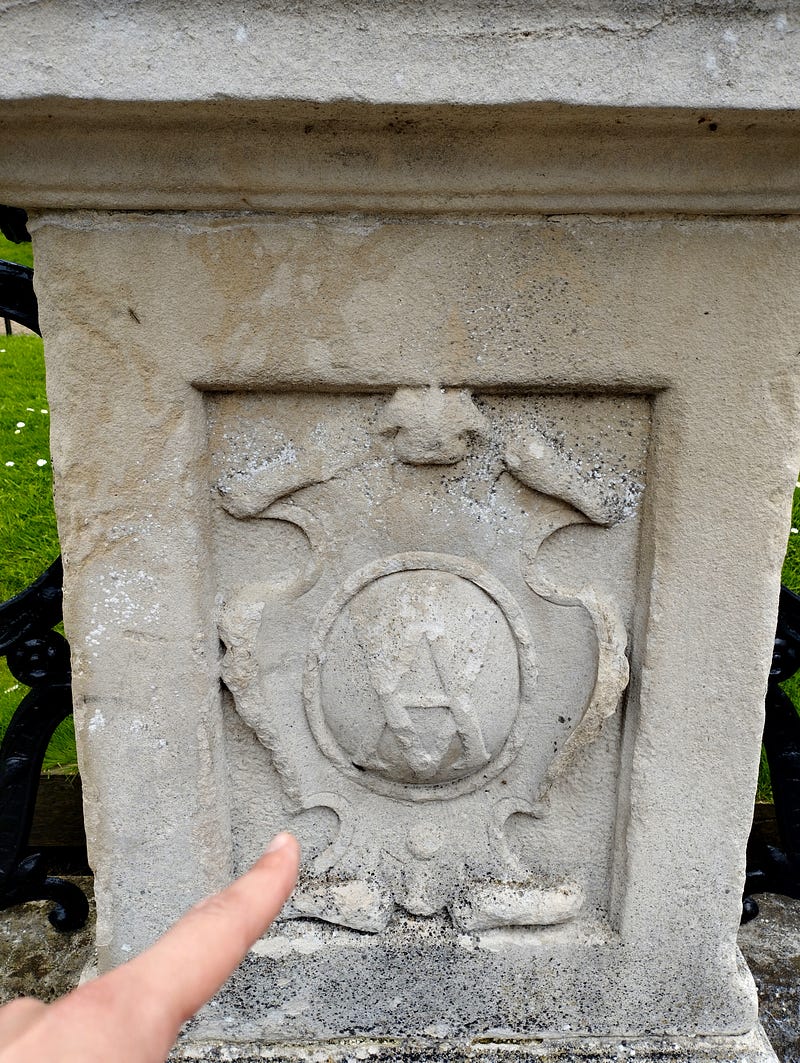 Antonello Mirone (Art Historian), ponting at the Queen Victoria and Albert symbol in Portland stone. Italian Gardens, London, 2023.