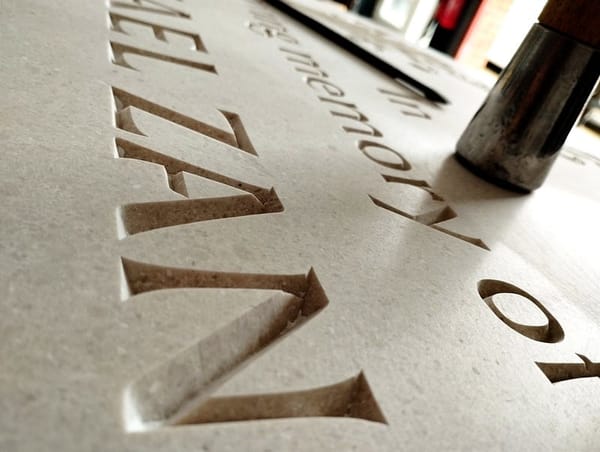 Letters carved in light coloured stone, Nabresina Headstone. Cut at Artisan Memorials, Canterbury.